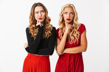 Portrait of two pensive young smartly dressed women