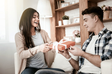 Open it. Attentive male person sitting in semi position while talking with his partner