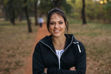 Portrait of beautiful woman preparing to exercise in park