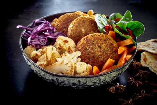 Close-up on bowl of vegetables and cutlets