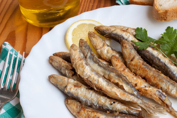 European anchovy fried with lemon and parsley garnish