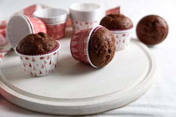 Homemade chocolate muffins (brownies) on white wooden background. Christmas food. Selective focus