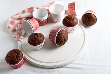 Homemade chocolate muffins (brownies) on white wooden background. Christmas food. Selective focus