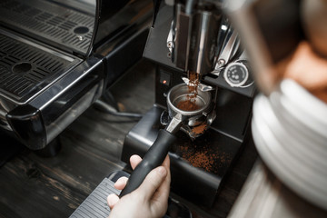 The process of grinding coffee professional machine for the bar in a modern cafe. Close-up