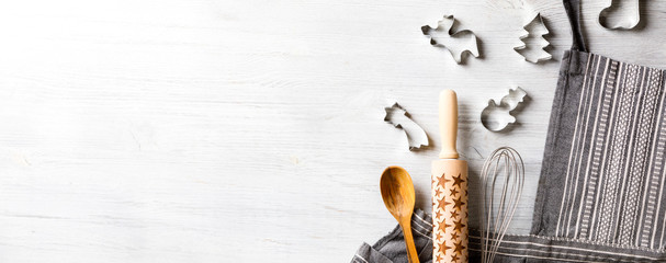 Kitchen apron on Holiday Background Concept of Christmas and New Year. Festive preparations. Poster design, rolling and whisk, a wooden spoon and cookie cutters and gingerbread. Copy space for Text.