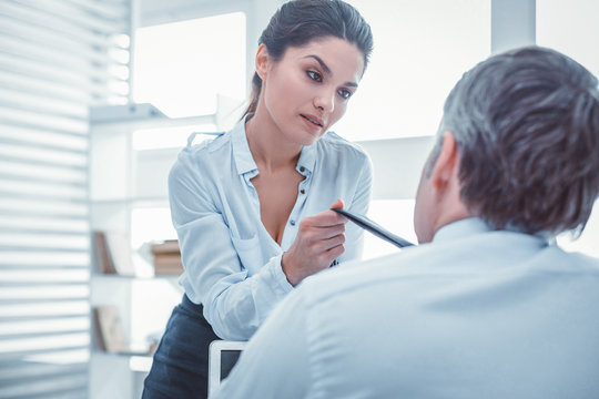 Rude Good-looking Female. Elegant Fit Female Seducing Her Coworker At Office Carrying His Tie And Leaning Over