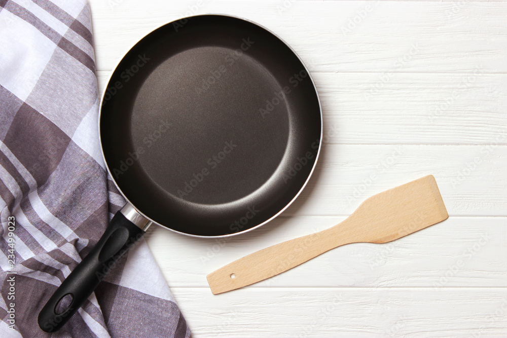 Wall mural frying pan and on the wooden table top view. Cooking.