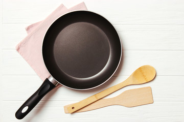 frying pan and on the wooden table top view. Cooking.