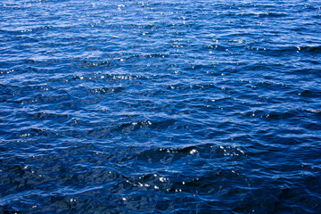 The brilliant blue water of the Baltic Sea glistens in the sun a few days after midsummer, near the Island of Nicklösa in the Åland Islands, Finland.
