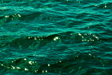 Close up of the emerald green water of the Baltic Sea as it glistens in the sun a few days after midsummer, near the Island of Nicklösa in the Åland Islands, Finland.