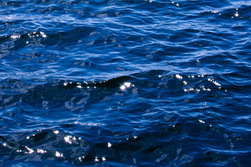 Close up of the brilliant blue water of the Baltic Sea as it glistens in the sun a few days after midsummer, near the Island of Nicklösa in the Åland Islands, Finland.