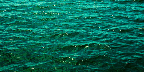 The emerald green water of the Baltic Sea glistens in the sun a few days after midsummer, near the Island of Nicklösa in the Åland Islands, Finland.