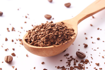 instant coffee in a spoon and coffee beans isolated on white. Aromatic coffee, coffee drinks
