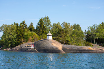 A sprawling toe-like smooth rocky boulder formation on the shore of an island in the Åland Islands, Finland, not far from the Island of Nicklösa.