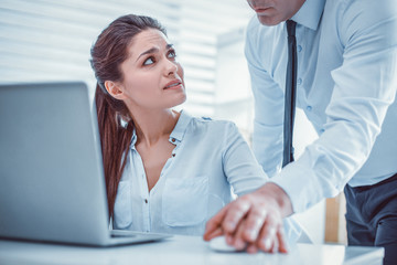 Confused female secretary. Young woman irritably asking her unprofessional coworker about his...