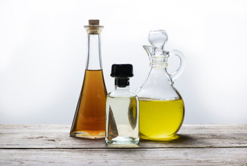 bottles of healthy oil on wooden table