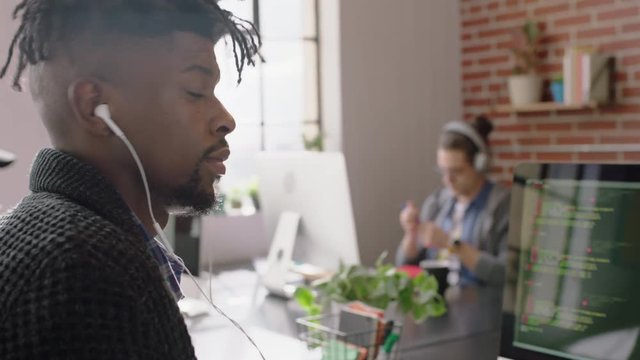 portrait african american man programmer coding network security software for startup company professional web developer smiling enjoying typing code on computer screen in successful office 