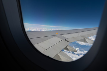 Fototapeta na wymiar Airplane wing view from window beautiful sky.