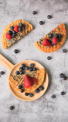 Waffles With Strawberry and Blue Berry in white plate.