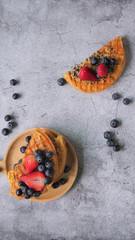 Fototapeta na wymiar Waffles With Strawberry, Blue Berry in wooden plate.