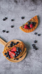 Waffles With Strawberry, Blue Berry in wooden plate.