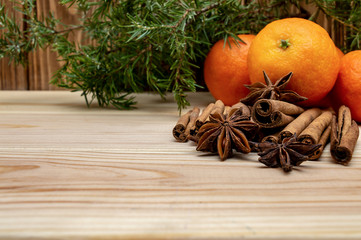 Fototapeta na wymiar mandarins on a wooden background cinnamon and star anise winter Christmas new year
