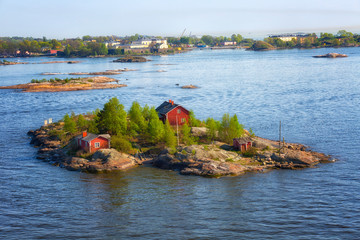 Finland, small red houses on an island in the Baltic Sea