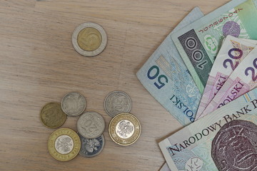 Set of Polish coins (Zloty, PLN) in silver and gold colors and paper bank notes as a symbol of currency in Poland 