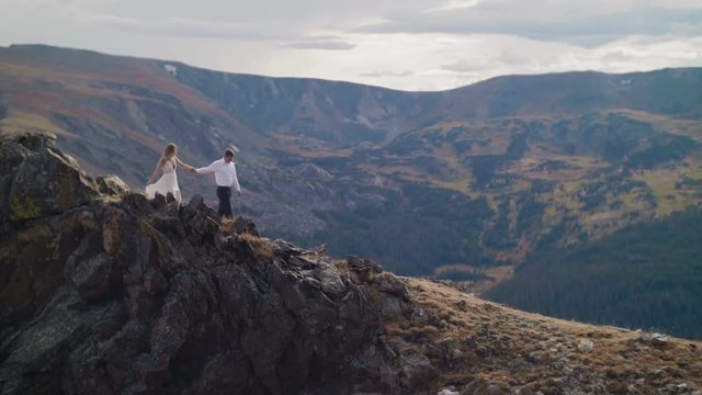 Couple Walking on Top of the Mountains