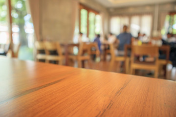 Restaurant interior with customer and wood table blur abstract background with bokeh light