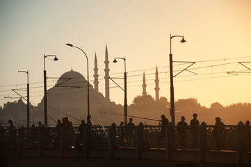 Istanbul silhouette. Suleymaniye Mosque and Galata Bridge in sunset