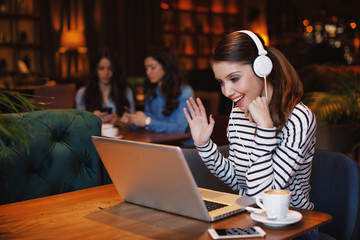 Woman have business meeting via video call in a cafe