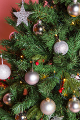 Obraz na płótnie Canvas Christmas tree with beautiful ornaments on pink background