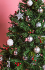 Christmas tree with beautiful ornaments on pink background