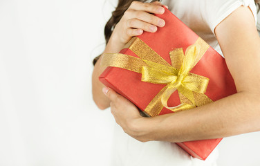 Young beautiful girl holds a gift in his hands close-up