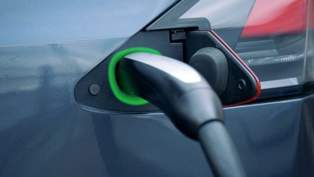 Illuminated socket of an electrocar with a plugged-in nozzle
