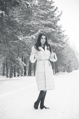 Pretty nice woman at christmas time outdoor , Fashionable lady in fur coat, magic seasone with good mood and luxury clothes