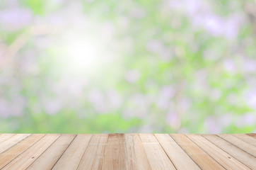Naklejka na ściany i meble wood table top counter bar perspective view on nature green blur bokeh background. montage for product banner display or design key visual layout background beautiful.