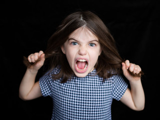 Portrait of sad scared brunette little girl