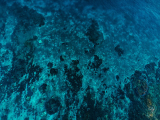 Turquoise ocean with coral reef, aerial drone shot. Top view. Ocean background