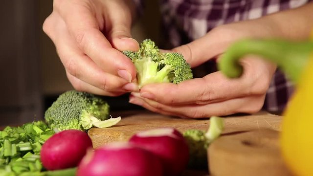 woman selects broccoli for vegetable salad making, healthy food concept