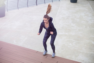 Fototapeta na wymiar Fitness woman jumping outdoor in urban enviroment