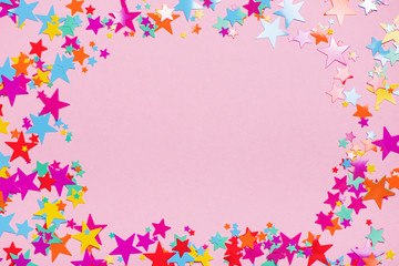 Obraz na płótnie Canvas Colorful confetti on pink background with horizontal copy space at center