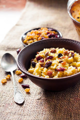 Sweet millet porridge with raisins and dried cranberries