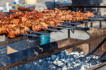 Grilled kebab cooking on metal skewer. Roasted meat cooked at barbecue