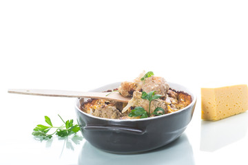 Cauliflower baked with meatballs in cheese sauce