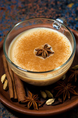winter spicy masala tea in a glass cup, vertical