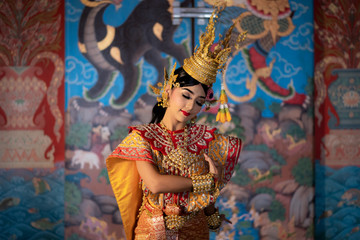 Fototapeta premium Thailand traditional or cultural dance in Thai costume. Thai beautiful girl is dancing called Nang Ram, it is noble Thai art of elegance.