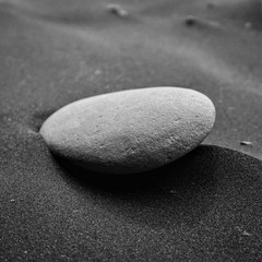 Fototapeta na wymiar A rock on the moon. Rock over black sand
