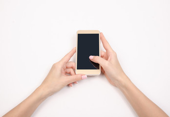 Mobile phone smartphone in hand on a white background isolation top view
